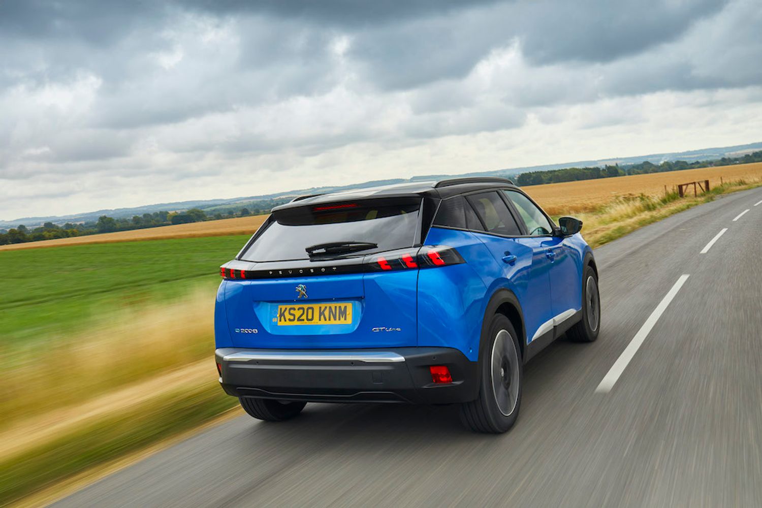 Peugeot E2008 electric car exterior rear driving 